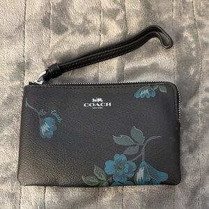 Brand new Coach Black Wristlet with Blue Floral Design